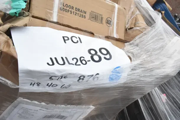 "Scratched pan rack, sink, and other items on pallet, labeled PCI JUL26-89, in original packaging, slight box damage."