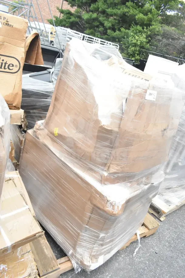 Plastic-wrapped pallet with boxed items, including brand new pan rack and sink, labeled "scratch and dent."
