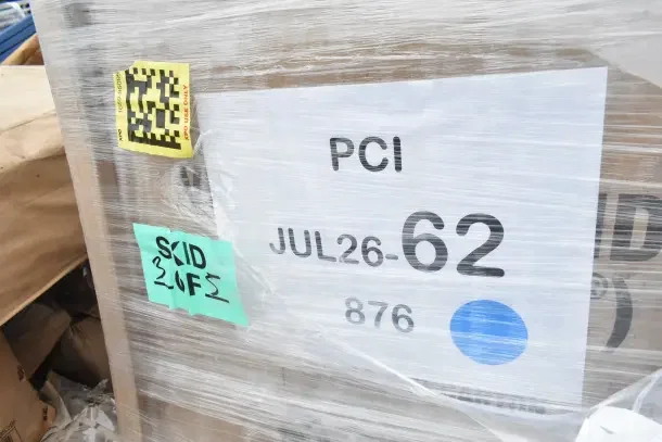 Plastic-wrapped pallet with visible labels reading "PCI JUL26-62" and "SKID 2 OF 5," containing brand new scratch and dent items.