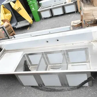 Brand new Regency 600DDTS384LFT dish table with 3 compartments, 16-gauge, 7' length, no legs, left drainboard, visible scratches.