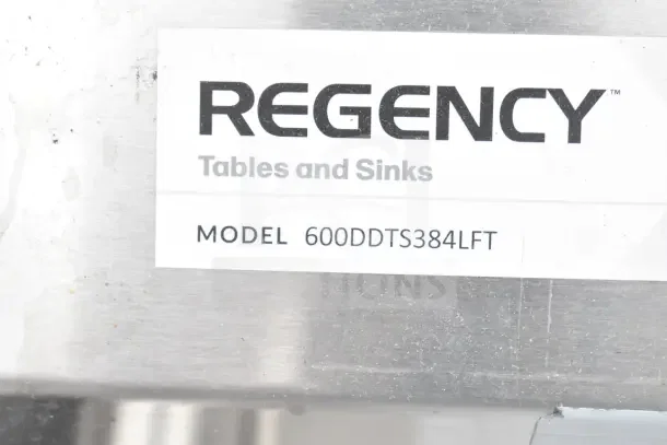 Brand new Regency 600DDTS384LFT 16-gauge 7' dish table with 3-compartment sink, left drainboard, no legs; scratch and dent.