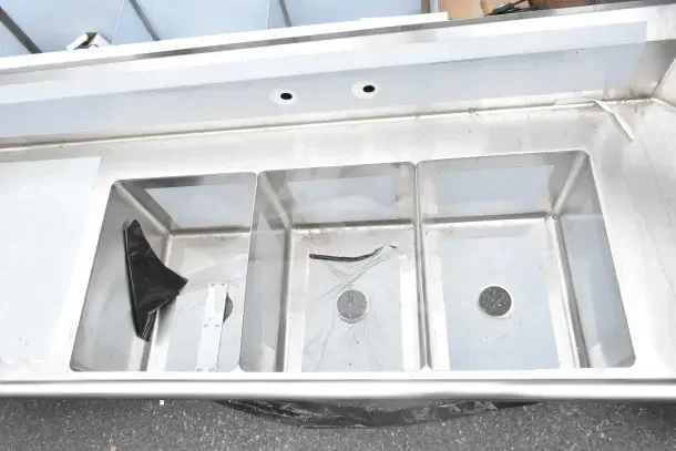 BRAND NEW Regency 600DDTS384LFT 3-compartment sink, 16-gauge stainless steel, 16"x20"x14" bowls, left drainboard, no legs.