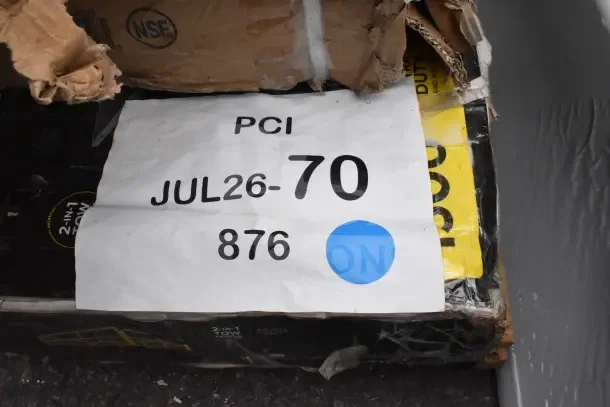 "Box with label 'PCI JUL26-70 876' containing 6 new scratch and dent items, including utility cart and equipment stand."