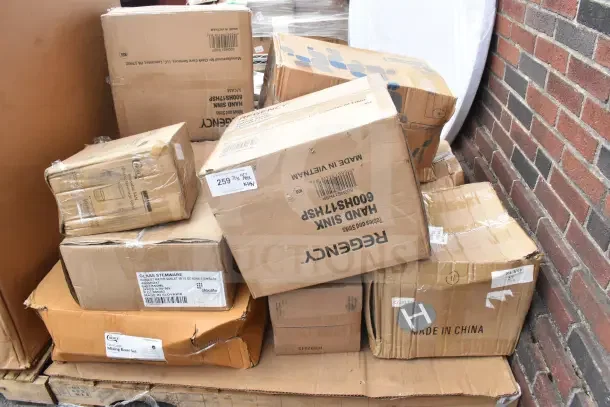 Boxes of scratch and dent items, including sinks, various brands visible, new condition, labels showing item specs and origin.