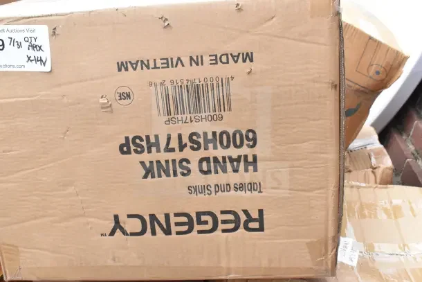 Cardboard box labeled "Hand Sink 600HS17HSP" by Regency, showing signs of wear. "Made in Vietnam" text visible.