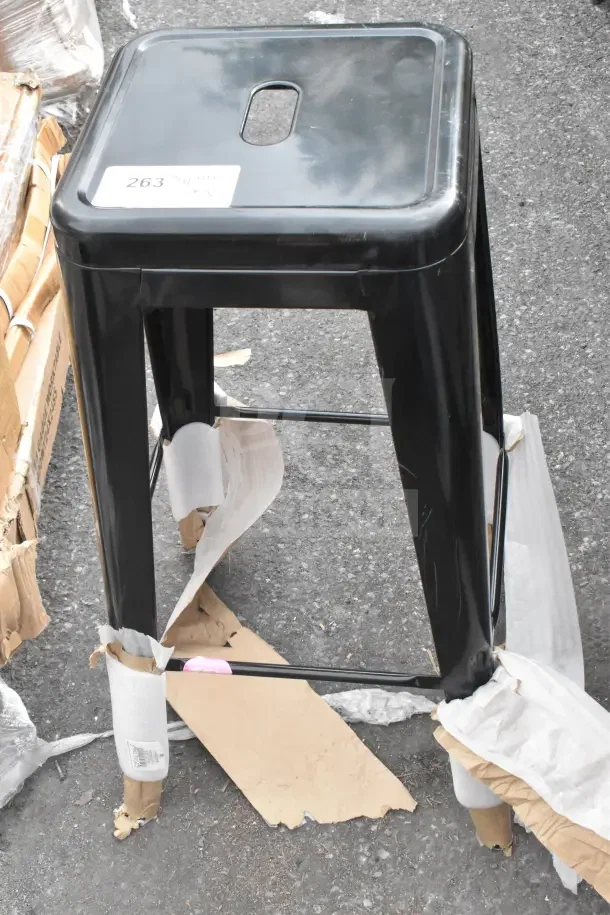 Lancaster Table & Seating Alloy Onyx Black Outdoor Backless Barstool, new with minor scratches, label "263" visible.