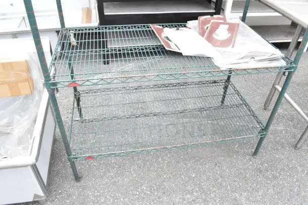 Green finish 4 tier wire shelving unit, sturdy metal construction, notable wear. Buyer must dismantle for shipping.