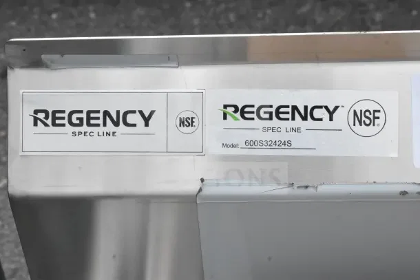 Brand new Regency 600S32424S 72" three-compartment utility sink, scratch and dent condition, with NSF labels visible.