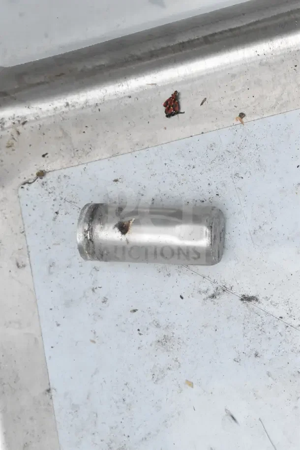 Alt text: Close-up of a Steelton 522CS31620LR commercial sink corner showing visible scratch and dent damage.