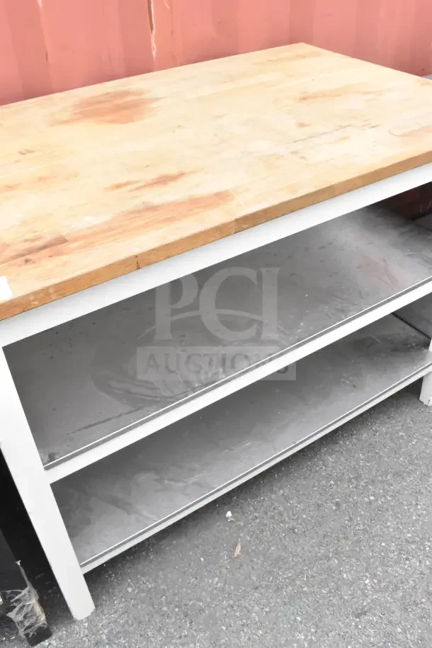 Wood pattern countertop with two-tier under shelf. Features robust wooden top, metal shelves; displays signs of wear.