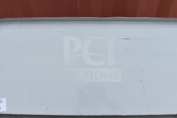 Gray wall mount shelf with visible surface scratches and a slight dent, robust metal construction, suitable for industrial use.