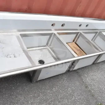 BRAND NEW Regency 121" three-compartment commercial sink with galvanized steel legs, two 24" drainboards, minor scratches.