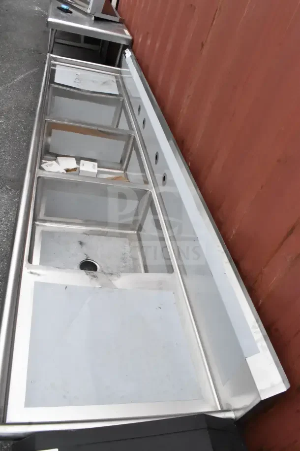 Brand new Regency 121" three-compartment commercial sink, scratch and dent, with galvanized steel legs, two 24" drainboards.