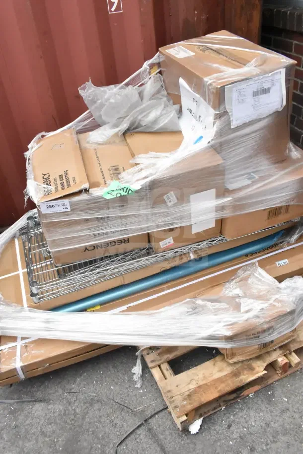 Stack of 10 brand new scratch and dent items, including wire shelf and pitcher, on a wrapped pallet. Boxes show labels and model info.