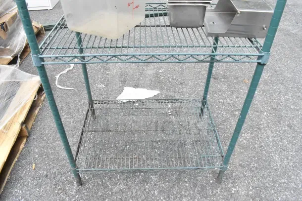 4-tier green wire shelving unit, used condition. Note visible for buyer dismantling and freight charges.
