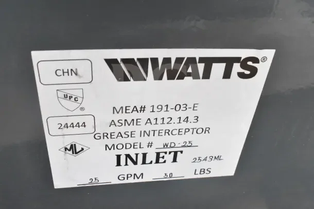 Label on Watts grease interceptor, Model WD-25, showing MEA# 191-03-E, ASME A112.14.3, inlet 25 GPM, weighs 30 lbs.