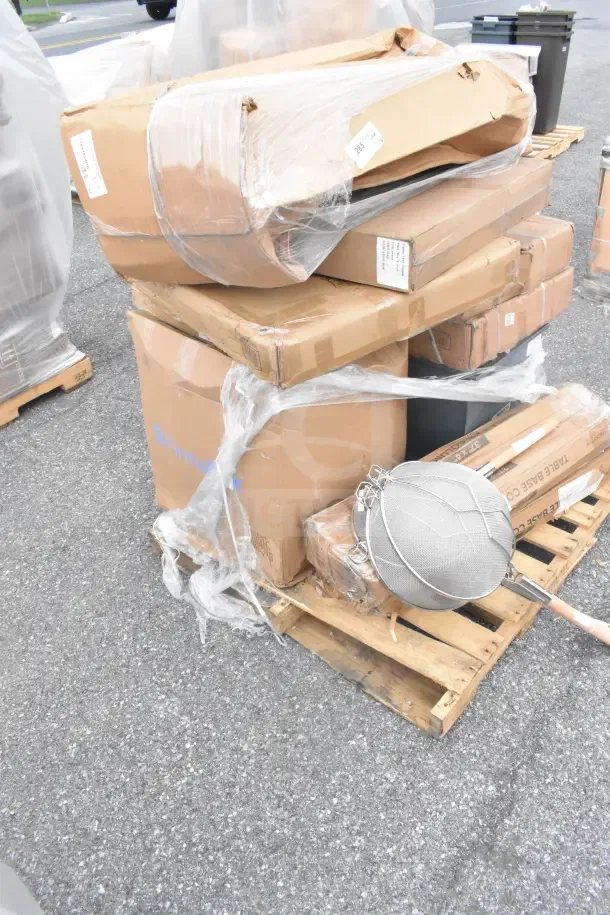 Stacked boxes on a pallet, wrapped in plastic. Includes a Regency 72" three-compartment utility sink, scratch and dent condition.