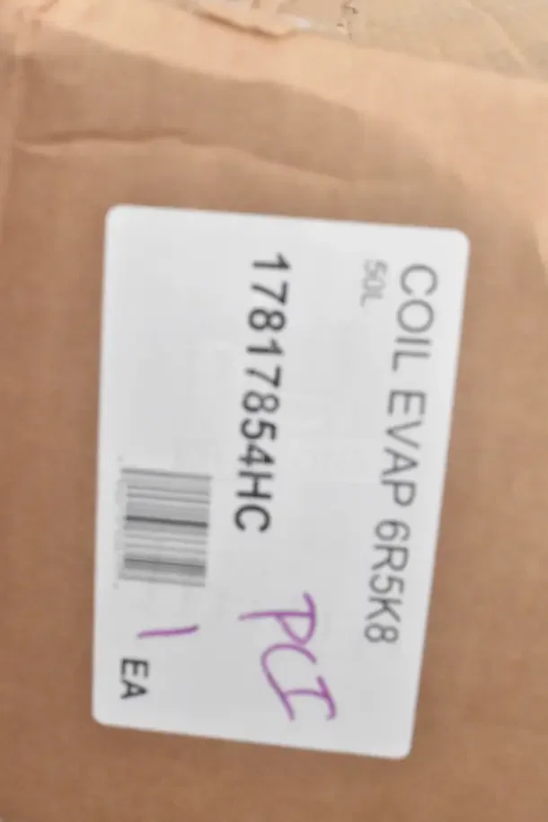 Label marked "COIL EVAP 6R5K8" with code "17817854HC," handwritten "PCI," and barcode, on brown packaging.