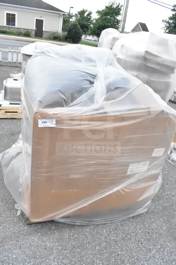 Sealed pallet of brand new scratch and dent items covered in plastic wrap, label displaying auction lot 286.