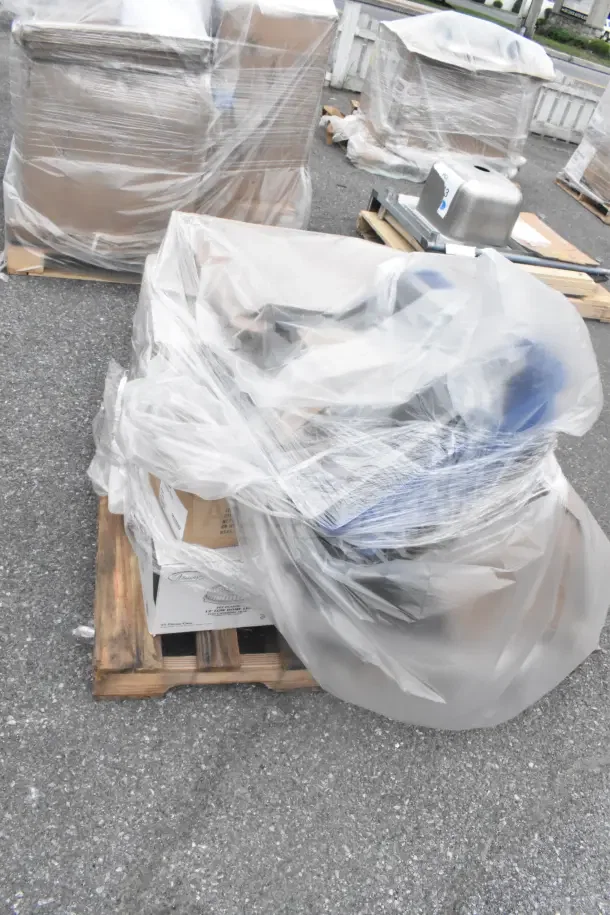 11 brand new scratch and dent items, including a Switch Kit, plates, and bowls, wrapped on a pallet.