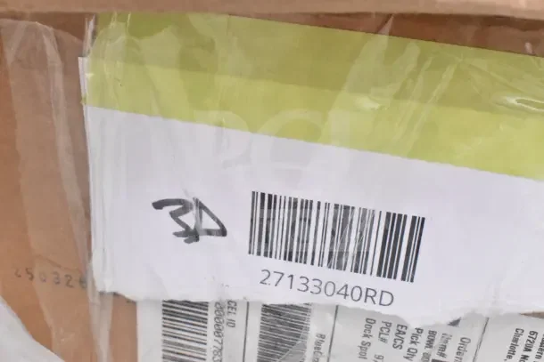 Box with barcode labeled "27133040RD" containing 11 new scratch and dent items like switch kit, plates, bowls.