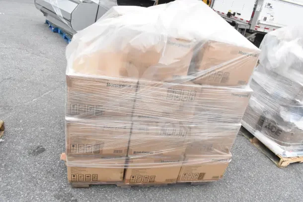 Pallet of Honeywell N95 respirator boxes wrapped in plastic, labeled "scratch and dent," brand new condition.