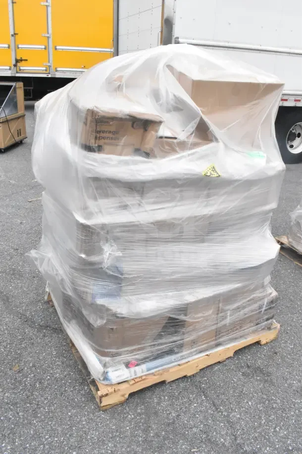 Plastic-wrapped pallet with 21 brand new scratch and dent items, including a glass rack, plates, and condiment caddy.