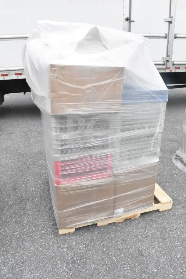 Plastic-wrapped pallet with boxes and crates, containing 34 new scratch and dent items, including glass caddies.