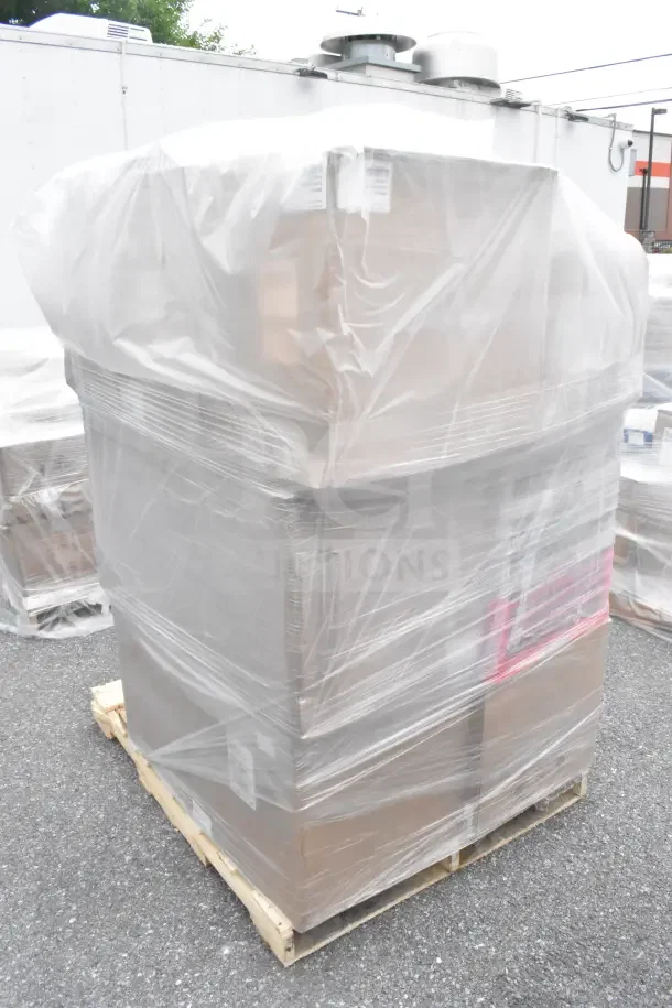 Plastic-wrapped pallet with 34 brand new scratch and dent items, including glass caddies, on an outdoor pavement.