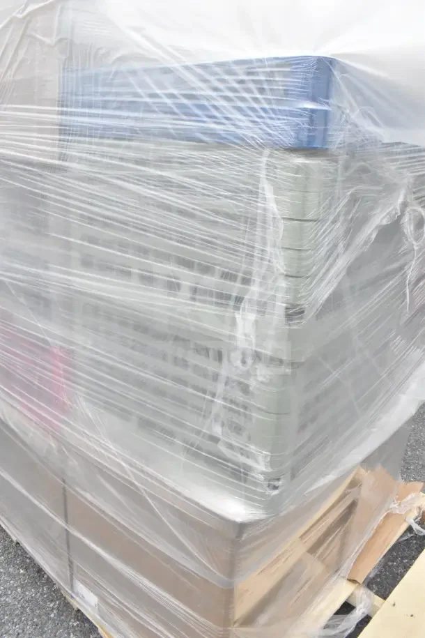 Plastic-wrapped pallet of 34 brand new scratch and dent items including glass caddies, ready for auction.