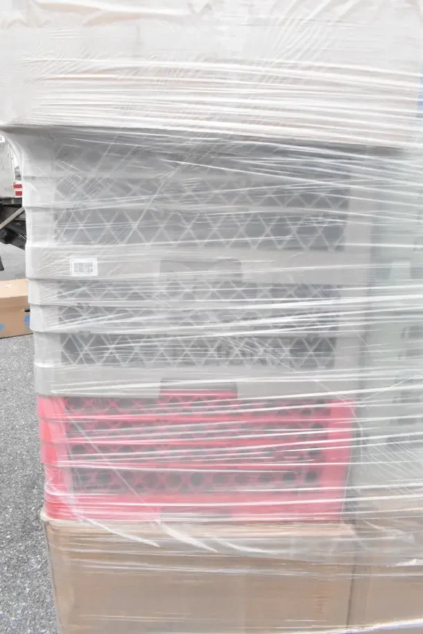 Plastic-wrapped stack of glass caddies, mixed colors, in new condition. Includes 34 scratch and dent items.