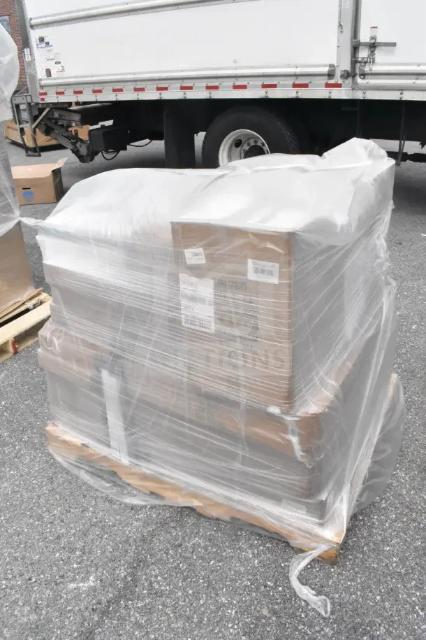 26 brand new scratch and dent items, including trays, bowls, and more, wrapped on a pallet, visible labels and shrink wrap.