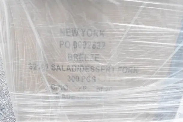 Plastic-wrapped package labeled "New York, PO 0002832, Breeze, 52/07 Salad/Dessert Fork, 300 PCS, Made in China."