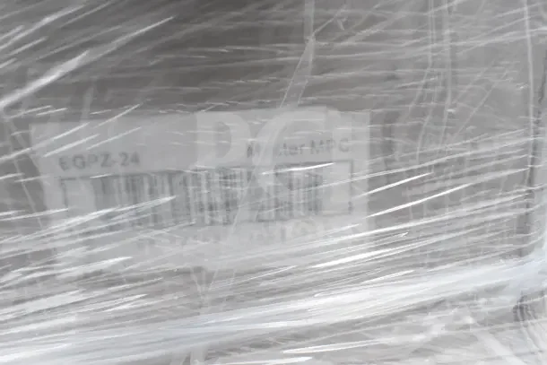 Pallet wrapped in plastic with label showing "EGPZ 24," unclear item details due to plastic covering.