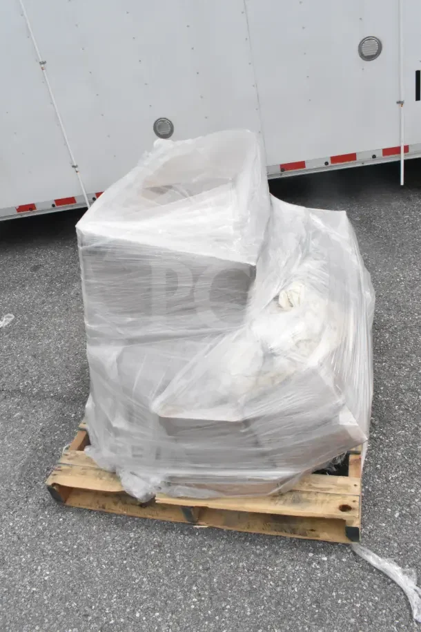 Shrink-wrapped pallet of mixed items, including disposal partition and dinner forks, marked as scratch and dent, brand new.