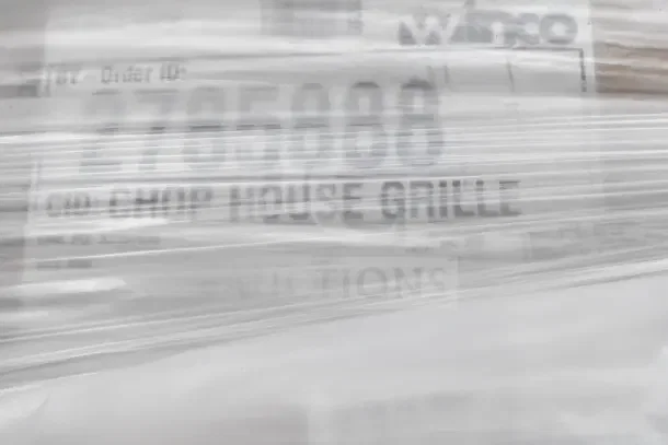 10 new scratch and dent items wrapped in plastic, featuring labels with text "2785888" and "Chop House Grille."