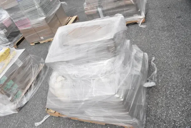 Plastic-wrapped pallet with brand new scratch and dent items, including disposal partition 2100718 and dinner forks 2785888.