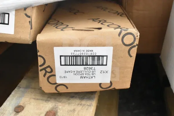 Cardboard box labeled "ARCOROC," containing Latham US Tea Spoon 18/10, model 13628, made in China.