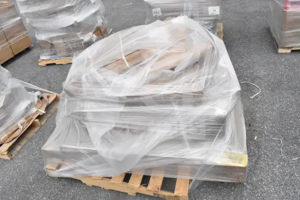 Plastic-wrapped pallet with 16 new scratch and dent items, including Wire Shell, Doughnut Fryer Screen, Eagle CSI-1448 Shelf Inlay.