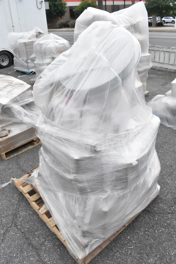Sealed pallet with 13 scratch and dent items including a mop bucket and umbrella canopy, wrapped in plastic for auction.