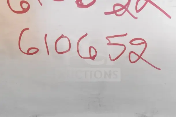 Alt text: Red marker numbers "610652" on a surface, likely indicating an item code or reference.