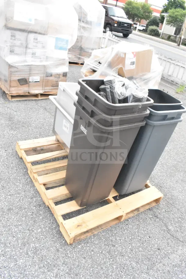 Brand new trash cans and sink on a wooden pallet, marked with a label indicating "lavex". Items are scratch and dent.