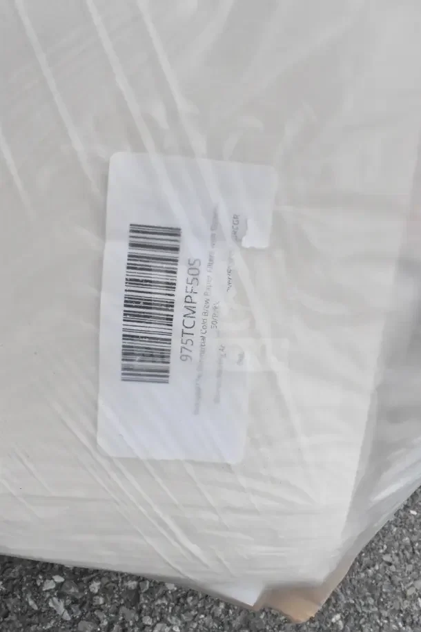 Clear plastic-wrapped items with barcode and label reading "975TCMPE50DS," indicating bakery and utensil items.