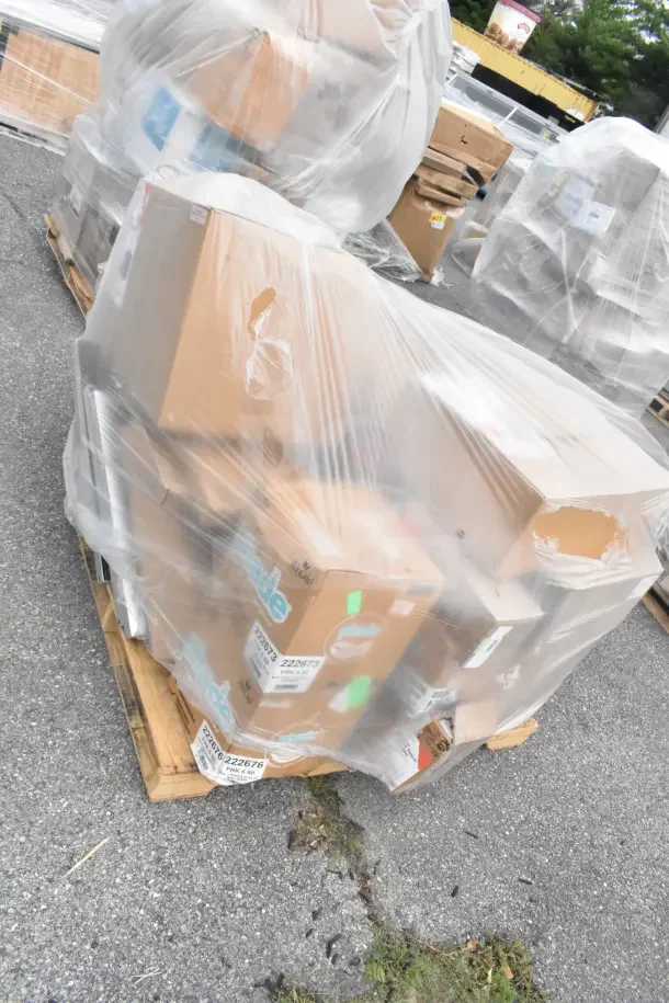 Pallet with 21 new scratch and dent items, including bakery boxes, forks, knives, lids, and lid organizer, shrink-wrapped.