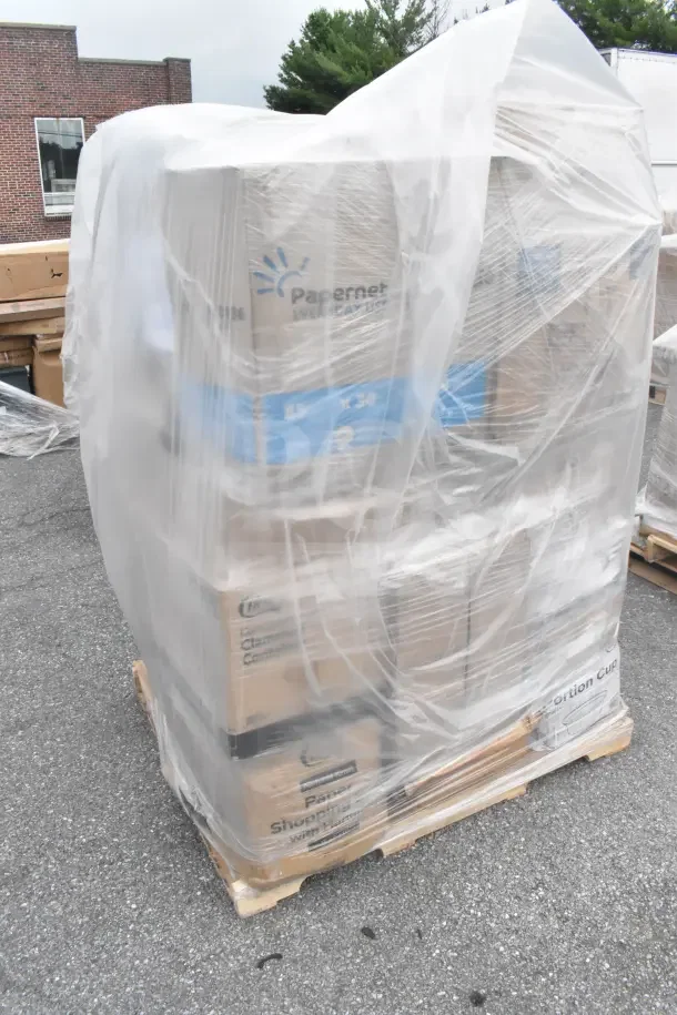 Pallet of 29 new scratch and dent items, including Papernet paper towels, wax paper, portion cups, wrapped in plastic.