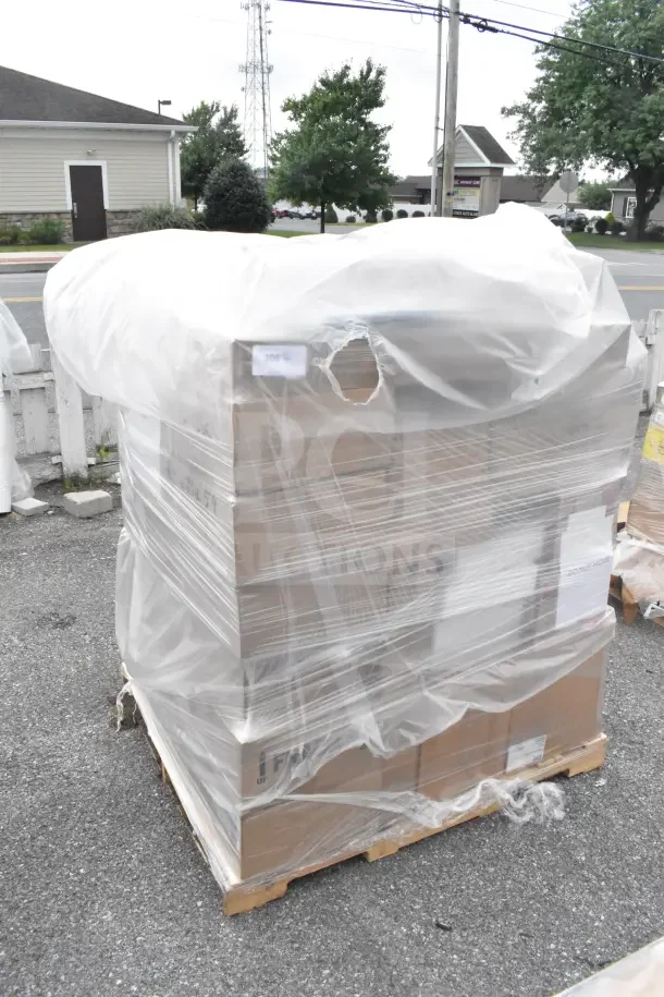 Stacked pallets wrapped in plastic containing 45 new scratch and dent items including glasses, spoons, and French food mill.