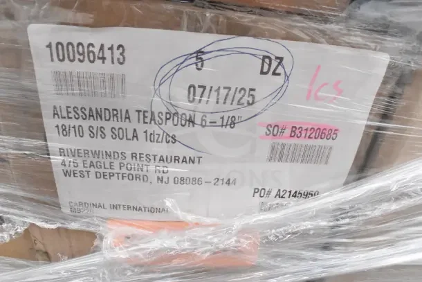 Label on wrapped items showing "Alessandria Teaspoon 6-1/8, 18/10 S/S SOLA, 1dz/cs," Riverwinds Restaurant, and shipping details.