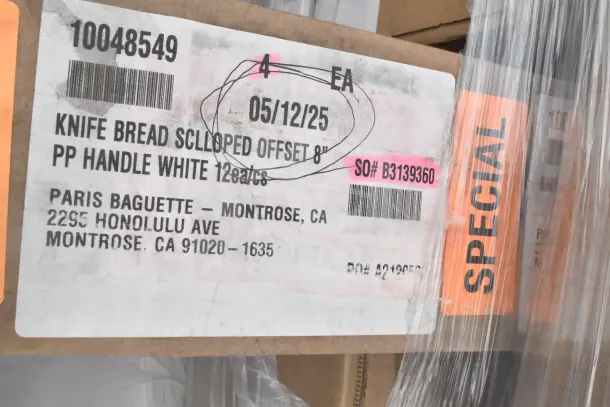 Label on boxed scratch and dent items, including bread knives, marked "SPECIAL." Paris Baguette, Montrose CA contact info.
