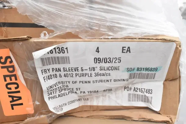 Cardboard box with sticker label showing "Fry Pan Sleeve 5-1/8 Silicone," 36 purple pieces per case by Vollrath Company.