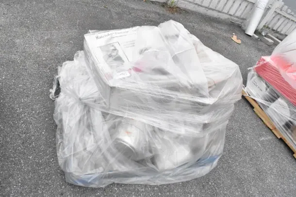 Plastic-wrapped pallet containing 10 brand new scratch and dent kitchen items, including pots and deep pans, visible packaging labels.